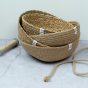 ReSpiin Jute & seagrass Natural Medium & large woven Bowls with on a grey surface with jute and twine next to the bowls