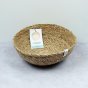 ReSpiin Seagrass Natural Medium woven Bowl with respiin white label and products label inside bowl on a grey surface on an off-white background