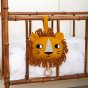 Roommate organic cotton lion baby music mobile hanging from a wooden cot