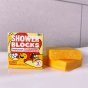Stack of Shower Blocks ginger and honey solid hair wash bars for itchy scalps on the side of a bath