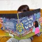 Girl sat on a sofa reading the wall and the wild childrens book by christina dendy