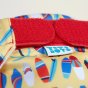 Close up of the velcro closures on the  Totsbots surfs up eco-friendly reusable swimming nappy 