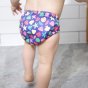 Close up of a toddler wearing the Totsbots mussel sea shell eco-friendly reusable baby swim pants 