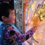 Young boy pointing at the Wonder Cloths large world map cloth