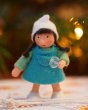 Ambrosius handmade felt winter dwarf girl figure in front of some blurry lights on a white floor