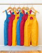 Collection of Babipur x Frugi organic cotton pluto cord dungarees hanging on a rail in front of a white wall