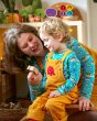 Woman and boy sat in a room playing and wearing matching Babipur x Frugi organic cotton Babipur world tops