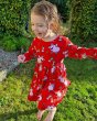 Girl running on some green grass wearing the DUNS Sweden organic cotton red pigs gather skirt dress