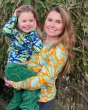 Woman carrying a young child wearing DUNS Sweden organic cotton long sleeve tops in the blue and orange frog prints