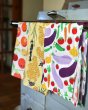 Close up of the DUNS Sweden organic cotton bee, citrus and cultivation tea towels hanging from an over handle