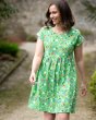 woman walking on a path wearing a Frugi organic cotton hallie slub dress in the hedgerow print