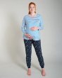 Pregnant woman stood in the Frugi eco-friendly cobalt breton meg maternity pyjama shirt on a grey background