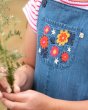 Close up of the embroidered flowers on the Frugi childrens eco-friendly chambray dungarees