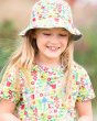 Close up of a young girl wearing a Frugi organic cotton floral sunhat