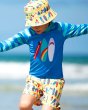 Young boy stood with his arms out wearing the Frugi eco-friendly shark board sun safe rash vest 