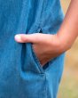 Close up of a young childs hand in the pocket of the Frugi chambray alexa dungarees