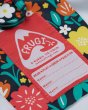 Close up of the hand-me-down label on the Frugi childrens floral rainy days waterproof coat