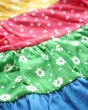 Close up of the Frugi kids hotch potch rosie rainbow dress patterns