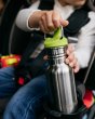 Close up of toddler in a car seat holding the Kid Kanteen 12oz stainless steel sippy bottle