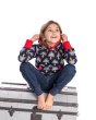 Child sat on a grey chest wearing the Maxomorra organic cotton kids lightning print lined hoodie
