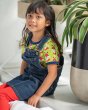 Girl sat down wearing the Maxomorra eco-friendly short sleeve fox top under a navy blue denim pinafore dress