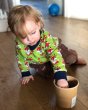 Young child playing on the floor with a wooden pot wearing the Maxomorra organic cotton long sleeve fox top