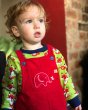 Young child stood wearing the Maxomorra organic cotton fox long sleeve top under some Babipur X Frugi dungarees