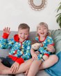 Girl and boy sat on a sofa wearing Maxomorra kids organic cotton pear print spring clothing