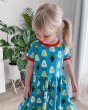 Girl looking down wearing the Maxomorra eco-friendly short sleeve spin dress in the pear print