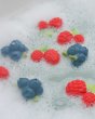 Oli and carol eco-friendly rubber raspberry and blueberry toys floating in some bubbly bath water