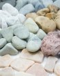 Close up of the Papoose collectable earth stones laid out on a white background