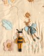 Childrens Roommate eco-friendly soft rag doll bee and butterfly toy laying on a cream duvet set