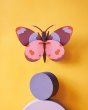 Studio roof bellissima butterfly wall decoration hanging on a yellow wall above a purple circle block