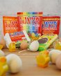 Tonys chocolonely eco-friendly fairtrade easter chocolates on a pile of straw, surrounded by mini wooden eggs and chicks