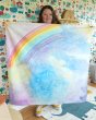 Woman stood holding up the Wondercloths large maxi play silk in the magical sky print