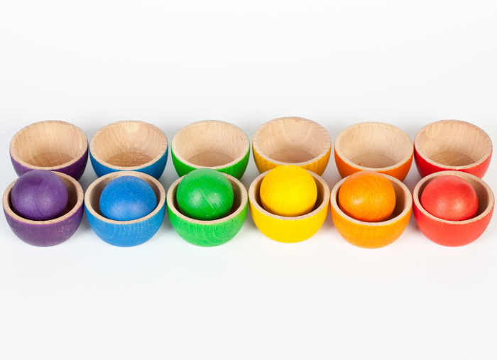 Grapat Bowls & Balls Wooden Toy Set - 12 small wooden toy bowls in 6 rainbow colours and 6 wooden balls. Colour matching and sorting, suitable from birth. White background.