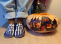 Child wearing Inch Blue Leather Baby Shoes - Bones stood next to a carved pumpkin on wooden flooring