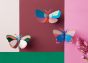 A collection of Studio Roof Butterfly decorations displayed on a painted wall 