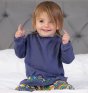 girl wearing  long sleeve blue tunic with colourful star embroidery along the hem from piccalilly