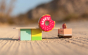 Candylab eco-friendly wooden donut shack toy set on a sandy background next to a toy donut truck