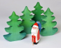 Close up of a Bumbu Father Christmas figure next to some toy fir trees