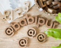 Reel Wood Letters, Numbers and Symbols laid out on a wooden floor spelling the word Babipur