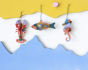 Studio Roof eco-friendly cardboard hanging sea creature ornaments dangling between a yellow and blue piece of wood