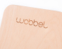 Close up of Wobbel logo from Original Beech Wood with Transparent Lacquer balance board on a white background 