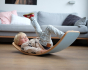Child laying on a Wobbel XL Beech Wood balance board with Felt in a living room