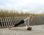 Woman doing a plank on a Wobbel XL Beech Wood balance board outside
