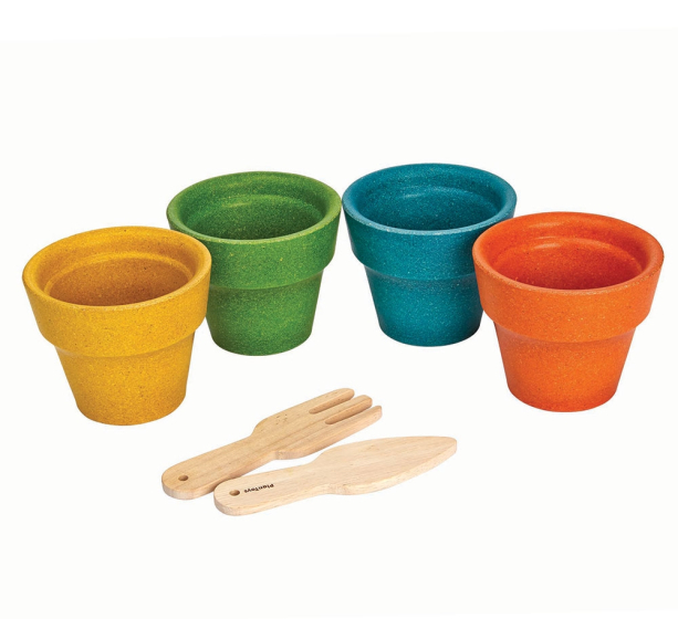 The PlanToys Flower pot set, four colourful plant pots in green, yellow, orange and blue made from PlanWood and a fork and trowl made from natural rubberwood