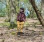 Child wearing brown autumn flowers LGR cardigan with yellow gingham trousers in the woods