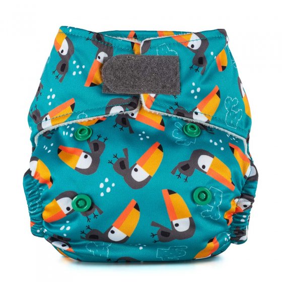 Baba + Boo eco-friendly reusable Newborn teal nappy with a repeat pattern of toucans all over, a grey velcro closure tab, photographed on a white background