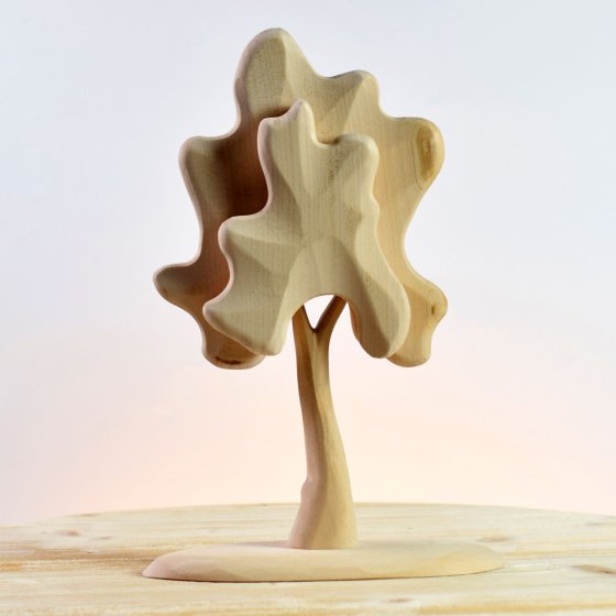 Bumbu eco-friendly and plastic free medium birch tree with a natural wood finish on a wooden table in front of a grey background